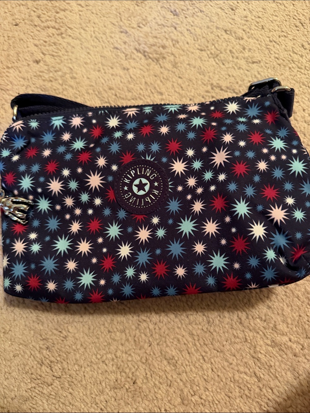 Kipling Navy Crossbody with Red, Light Blue, and White Star Print